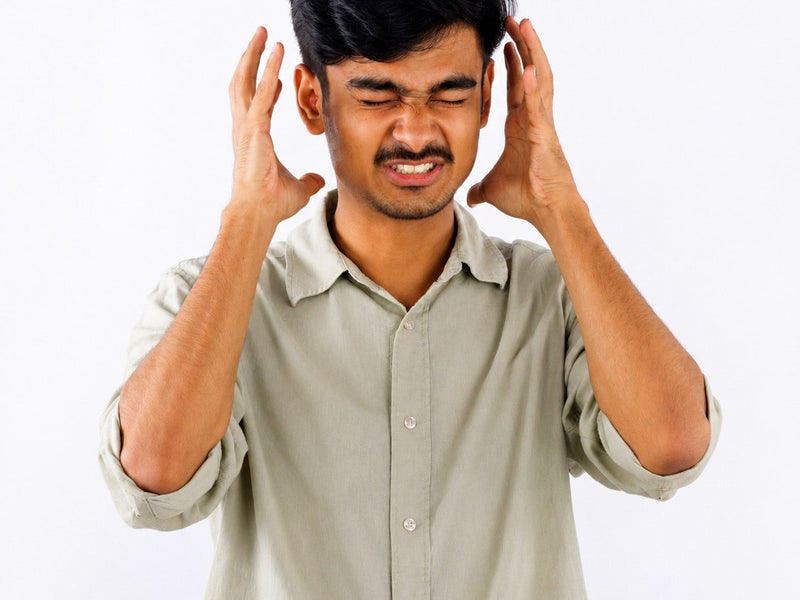 Young man experiencing anxiety related to digestive health